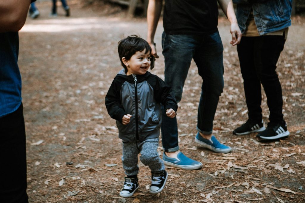 boy in black crew neck t-shirt and blue denim jeans standing beside boy in black